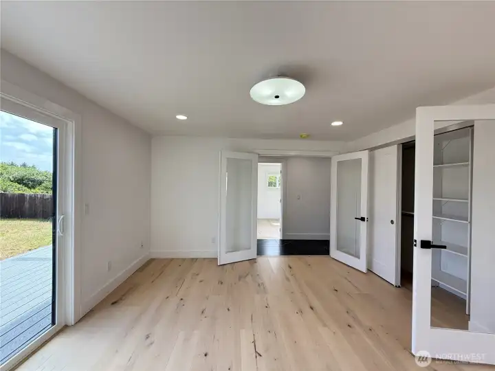 MAIN FLOOR 3RD BEDROOM WITH 2 FRENCH DOOR OPENING AND A SLIDING GLASS DOOR