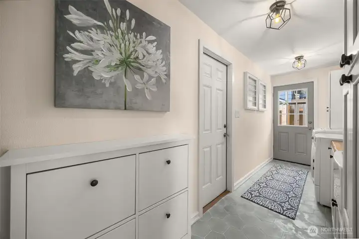 Well-appointed laundry room with utility sink and built-in storage.