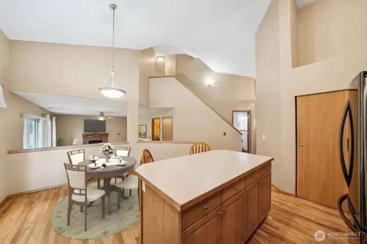 Kitchen to the family room  - pantry door to the right.   (virtually staged)