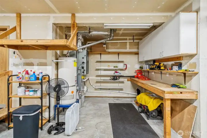Garage shop area with cabinets.