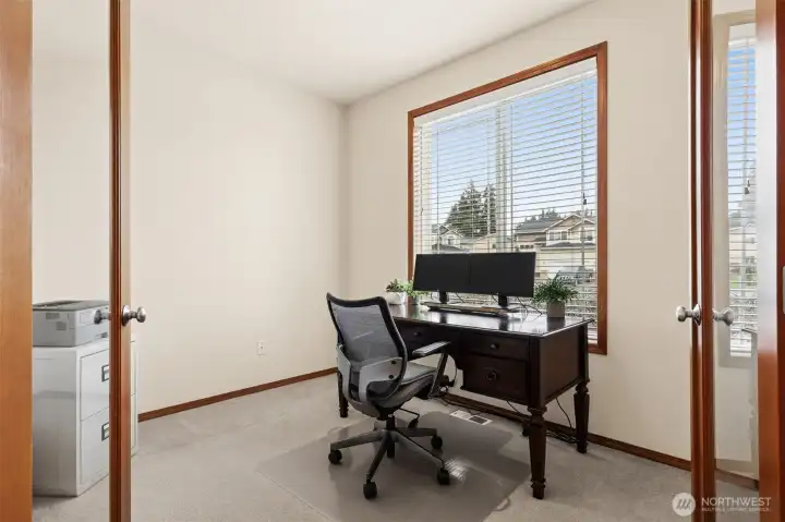 Main floor office with glass French doors & and a lovely view out the front lawn.