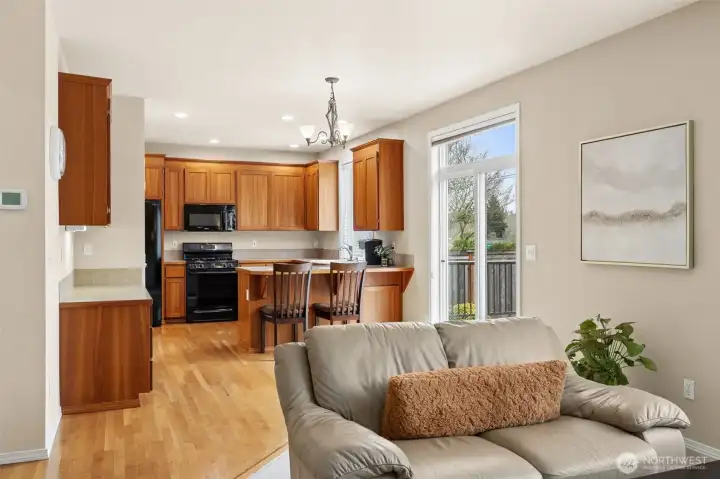 View of the kitchen from the family room with sliding door and transom for good access to the backyard & deck area.