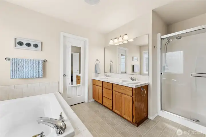 Beautiful five piece bathroom with large walk-in closet, oversized soaking tub, double sink vanity & walk-in closet.