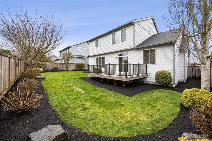The backyard offers a spacious Trex deck, perfect for relaxing or entertaining, along with plenty of room to run and play with pets. The professionally landscaped and fully fenced yard creates a beautiful and well-maintained outdoor space to enjoy year-round.