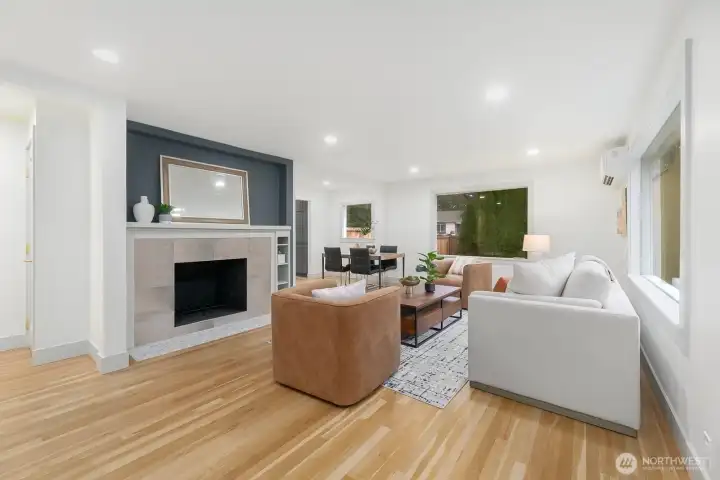 Light & bright open floor plan with gleaming hardwood floors, wood burning FP & mini-split heating/cooling.