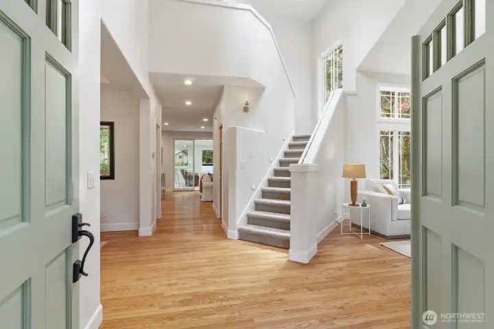 Step into the welcoming foyer with gleaming hardwoods, vaulted ceilings, and fresh interior paint—setting the elevated tone for the entire home.