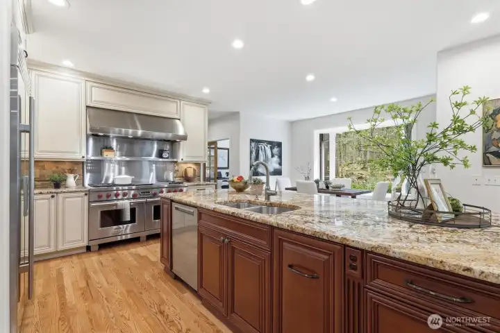 All high-end kitchen appliances stay: Wolf range with double oven, Wolf microwave, Sub-Zero refrigerator, and Miele dishwasher—perfect for the home chef.