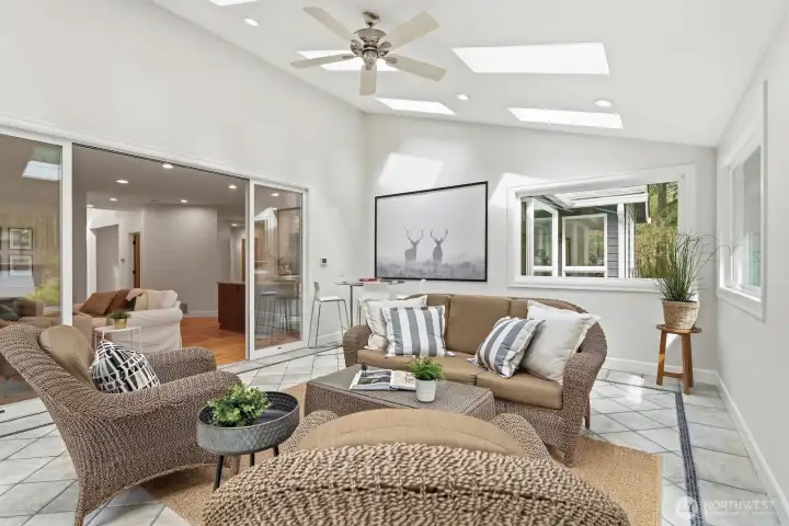 Elegant glass sliders connect the family room and sunroom, enhancing natural light and openness throughout.