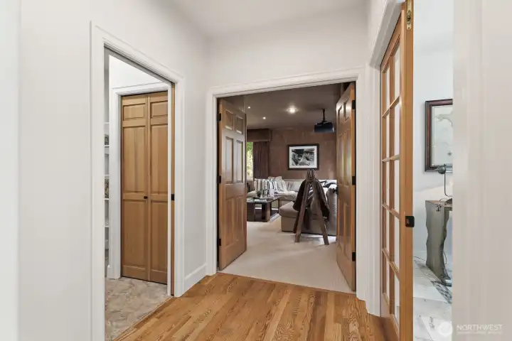 The home flows seamlessly with a hallway connecting the main-floor theatre room, laundry room and office.