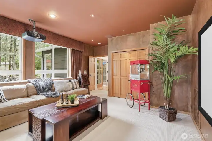 Theater setup with blackout curtains, screen, projector, and electronics—all included for memorable movie nights.