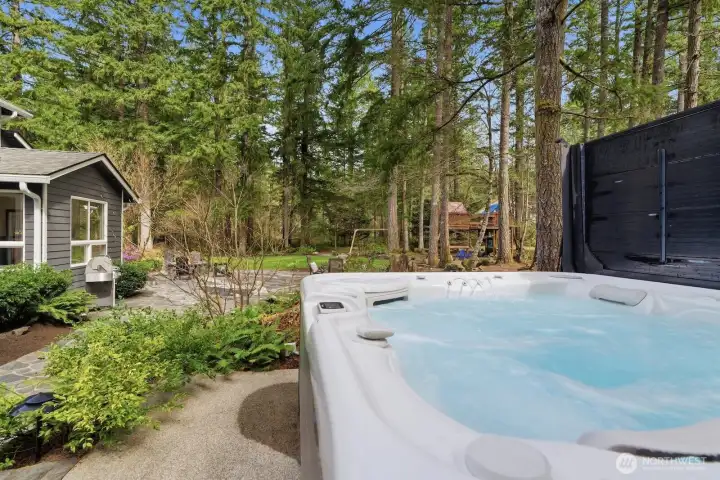 Relax in a new saltwater hot tub while the 8-zone Rain Bird sprinkler system keeps the lush grounds beautifully irrigated.