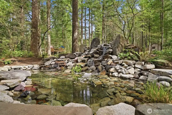 Professionally designed and meticulously maintained pond with cascading waterfall features.