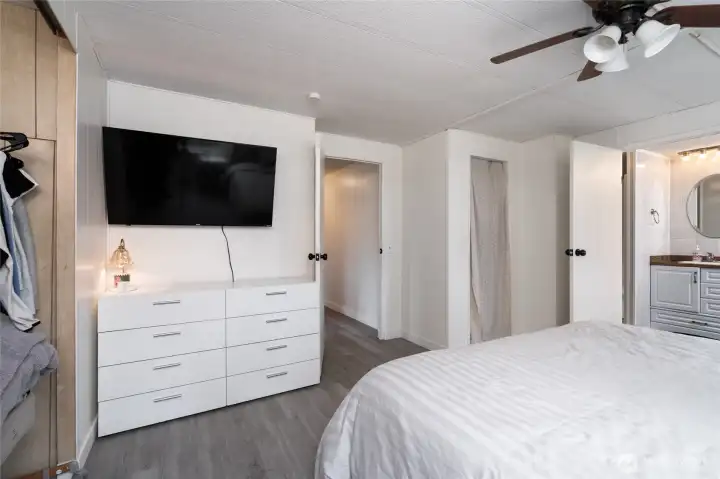 Another view of the expansive primary bedroom showcasing ample wall space, modern finishes, and easy flow to adjoining rooms, including the ensuite bath.