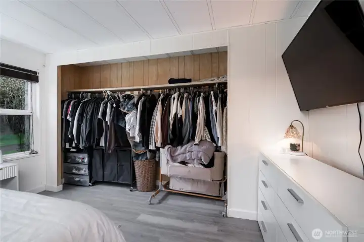 Large open-concept closet with extensive hanging space, built-in shelving, and storage bins—perfect for organizing a full wardrobe. Functional and accessible design enhances everyday living.