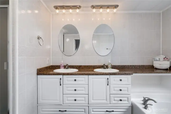 Dual sinks adorn the primary bathroom.