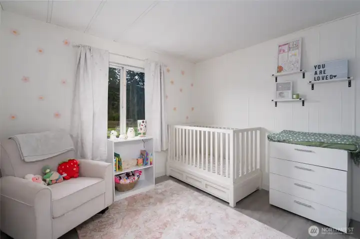 Charming nursery or bedroom with soft natural light, neutral color palette, and cozy finishes. Perfect as a baby room, guest space, or home office.