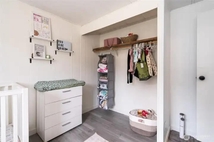Functional closet space within the nursery featuring hanging storage and shelving, ideal for organizing clothing, toys, and essentials.
