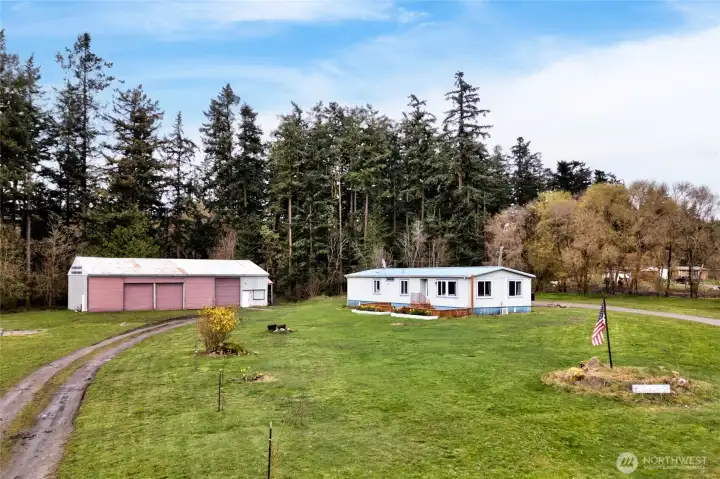 Well-maintained manufactured home with adjacent large shop/garage, offering a unique combination of residential comfort and workspace. Ideal for those needing both living space and storage or workshop capabilities.