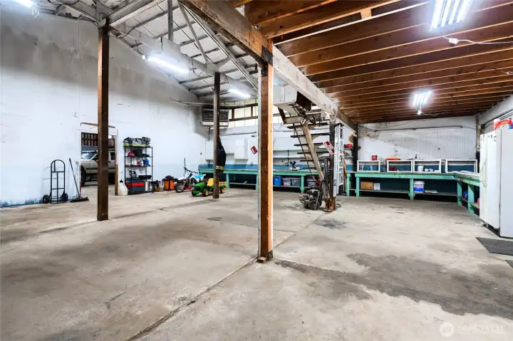 Expansive workshop or garage space with high ceilings, exposed beams, and ample room for projects, storage, or equipment. Ideal for hobbyists or contractors.