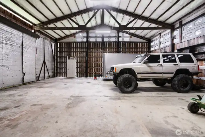 Massive detached shop or garage with oversized doors and plenty of room for vehicles, RVs, or business use. A rare and valuable feature for added versatility.