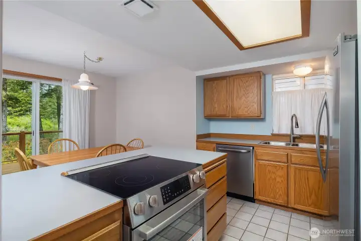 Cozy kitchen with newer appliances and ceramic tile floor.