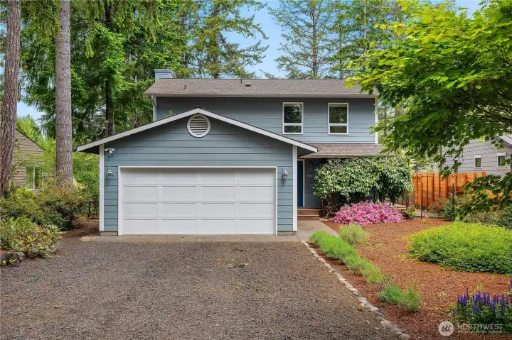 Front view. Clematis blooming by the front door.