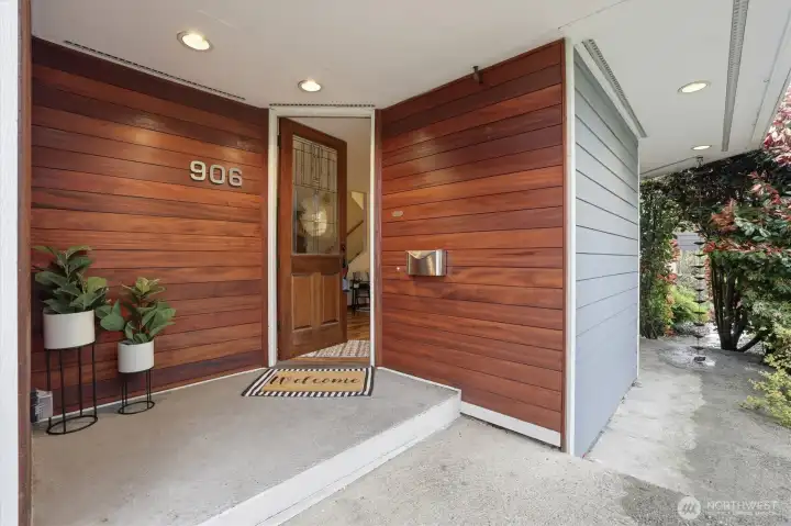 Covered entry with Tigerwood accent walls.