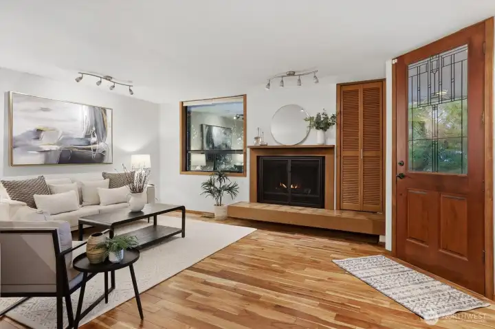Wood burning fireplace frames the living room and entry.