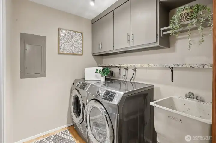 Utility room with adjacent half bath on main floor.