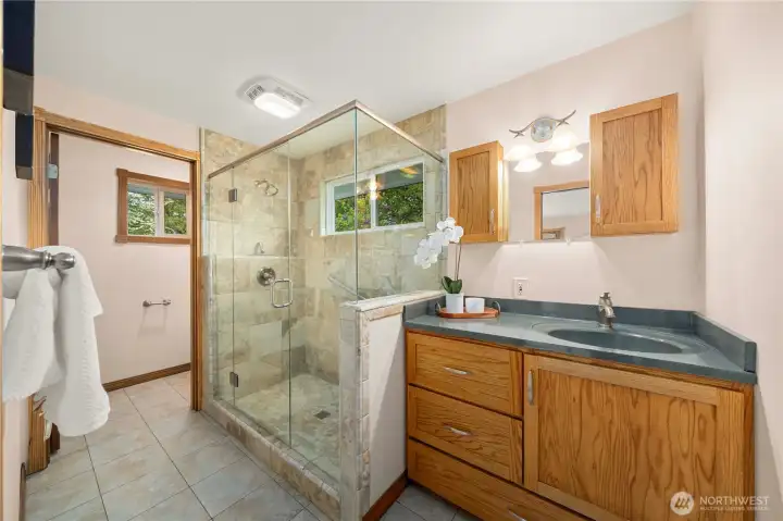 Private bath with a glass step-in shower.