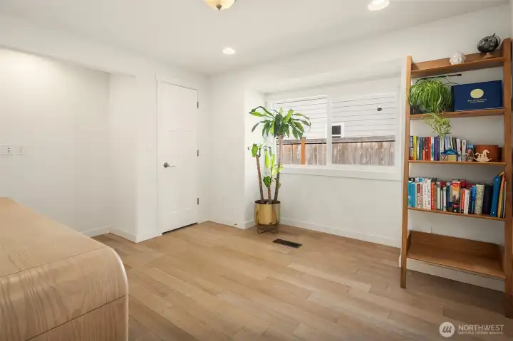 3rd bedroom. Currently used as a versatile flex room ideal for a home office, study, fitness space, or guest area, featuring hardwood floors, oversized windows, and bright natural light.
