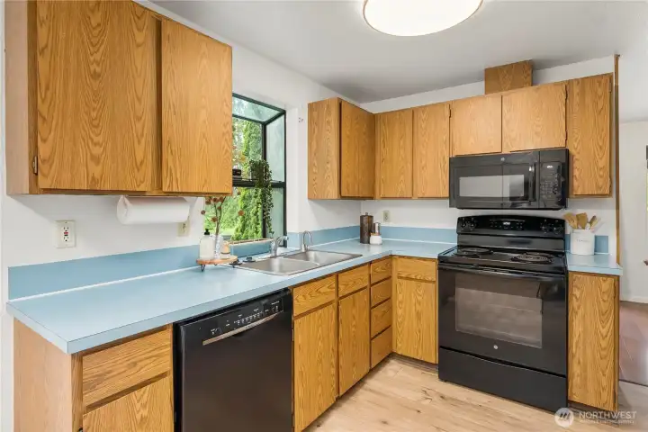 Garden window brightens the kitchen’s generous workspace Garden window brightens the kitchen’s generous workspace