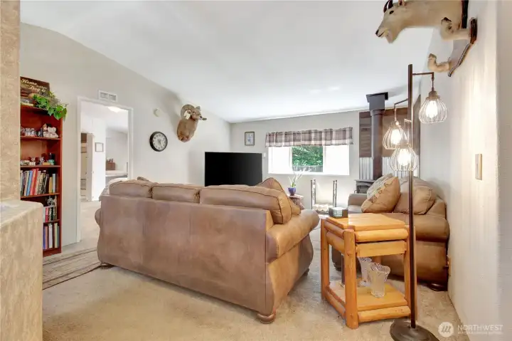 First entry into the vaulted ceiling living room with the Primary bedroom to the left.