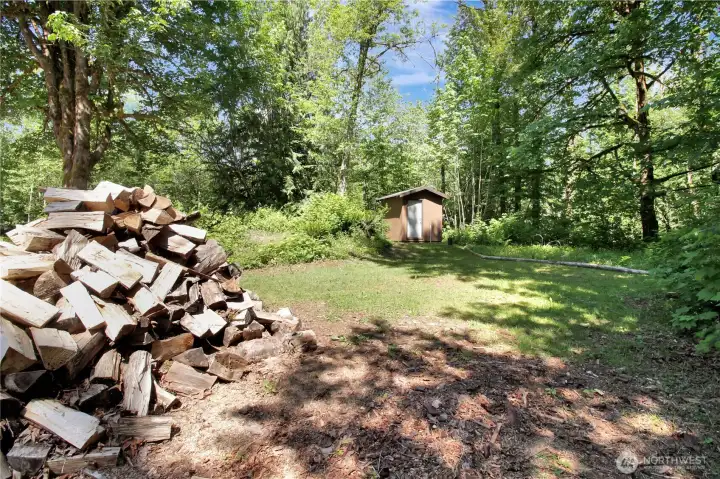 Wood is drying and will be ready for this coming season! It comes with the home! Well house and Pond in the distance.