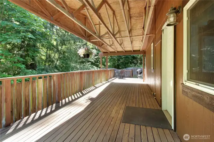 Covered back porch with entry to the kitchen nook area, with quick washer and dryer access.