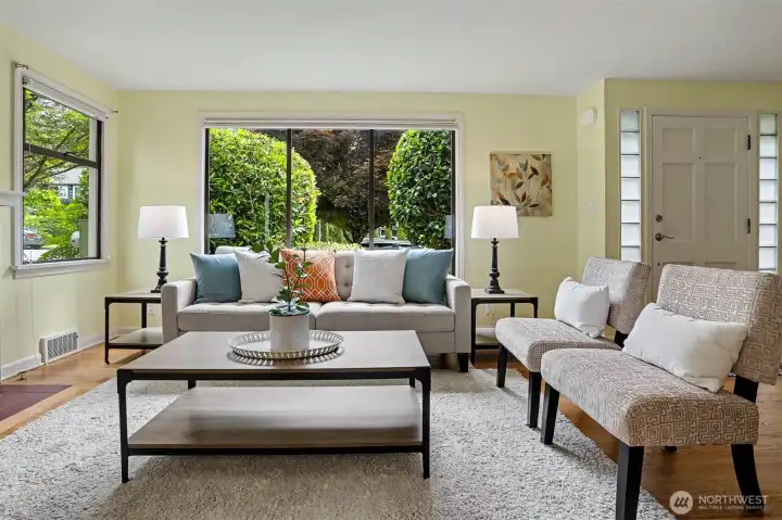 The living room has large sun soaked windows and is a very welcoming space.
