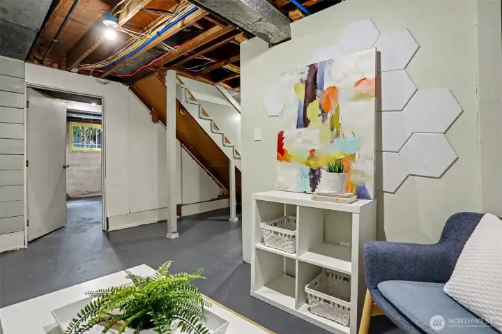 This is a little TV nook looking into a large unfinished room with endless possibilities.