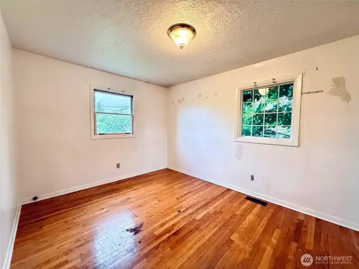 Primary bedroom with hardwood floors Primary bedroom with hardwood floors
