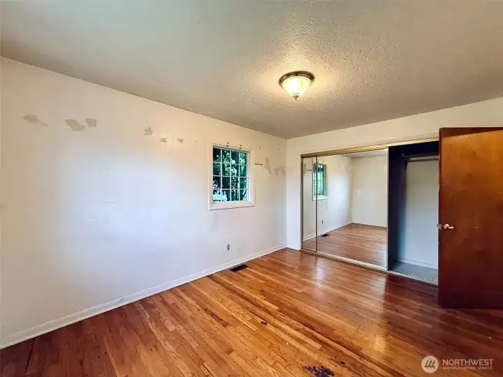 Primary bedroom with hardwood floors Primary bedroom with hardwood floors