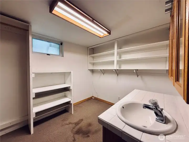 Basement bonus storage room with sink and cabinet Basement bonus storage room with sink and cabinet
