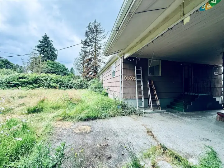 Large fenced backyard with covered patio behind the garage Large fenced backyard with covered patio behind the garage