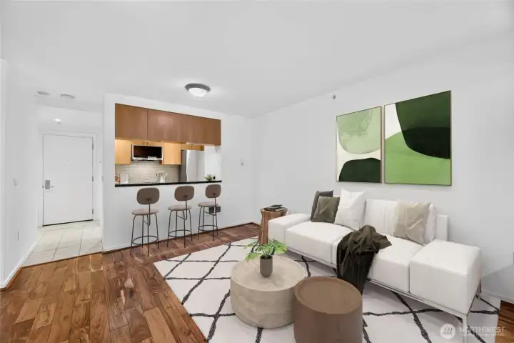 Virtually staged to show furniture option. A small table and chairs would also fit by the chairs. (High counter does not overhang.) Virtually staged to show furniture option. A small table and chairs would also fit by the chairs. (High counter does not overhang.)