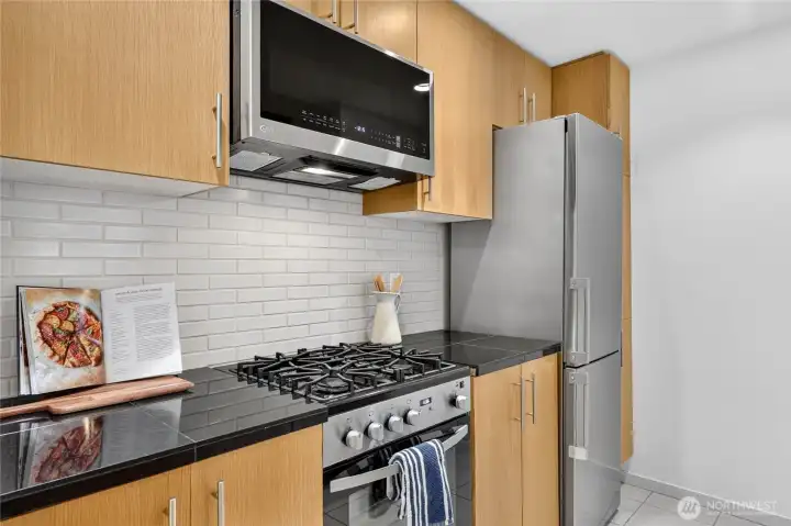 This sleek microwave was installed in 2024 and the gas range was installed in 2021. This sleek microwave was installed in 2024 and the gas range was installed in 2021.