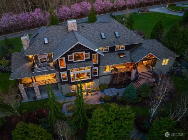 Exterior spaces include Mt. Baker view deck off master with propane fireplace, wrap around covered porch on main, intimate covered porch with vault and skylight off kitchen on main, covered patio on lower and uncovered patio on lower featuring bespoke hard-scaped fire pit.