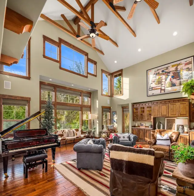 Vaulted ceilings, clerestory windows and a west-facing outlook flood this enormous room with natural light.  The far door at center right leads to the main level's wrap-around covered deck.