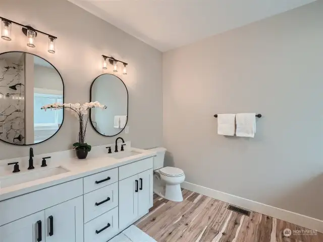 Dual sinks in primary bathroom with quartz countertops