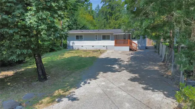 Another view of the home, surrounded by mature landscaping.