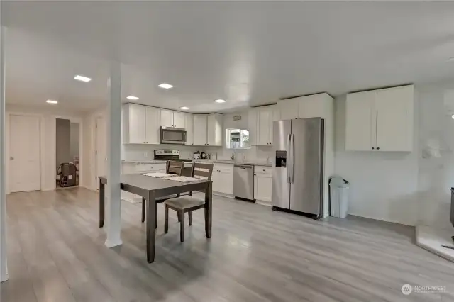 Wonderful open concept kitchen area. Glistening new floors and new lights