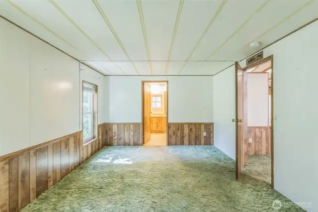 Back to the other end of the home where the oversized primary suite lies looking towards the en-suite bath.
