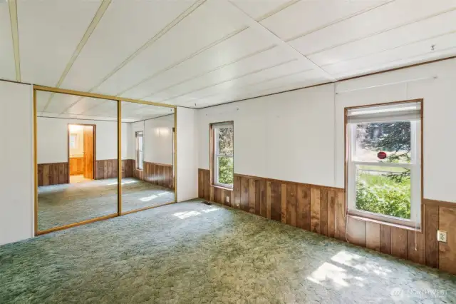Large double door mirrored closet and two windows that allow an abundance of natural light.